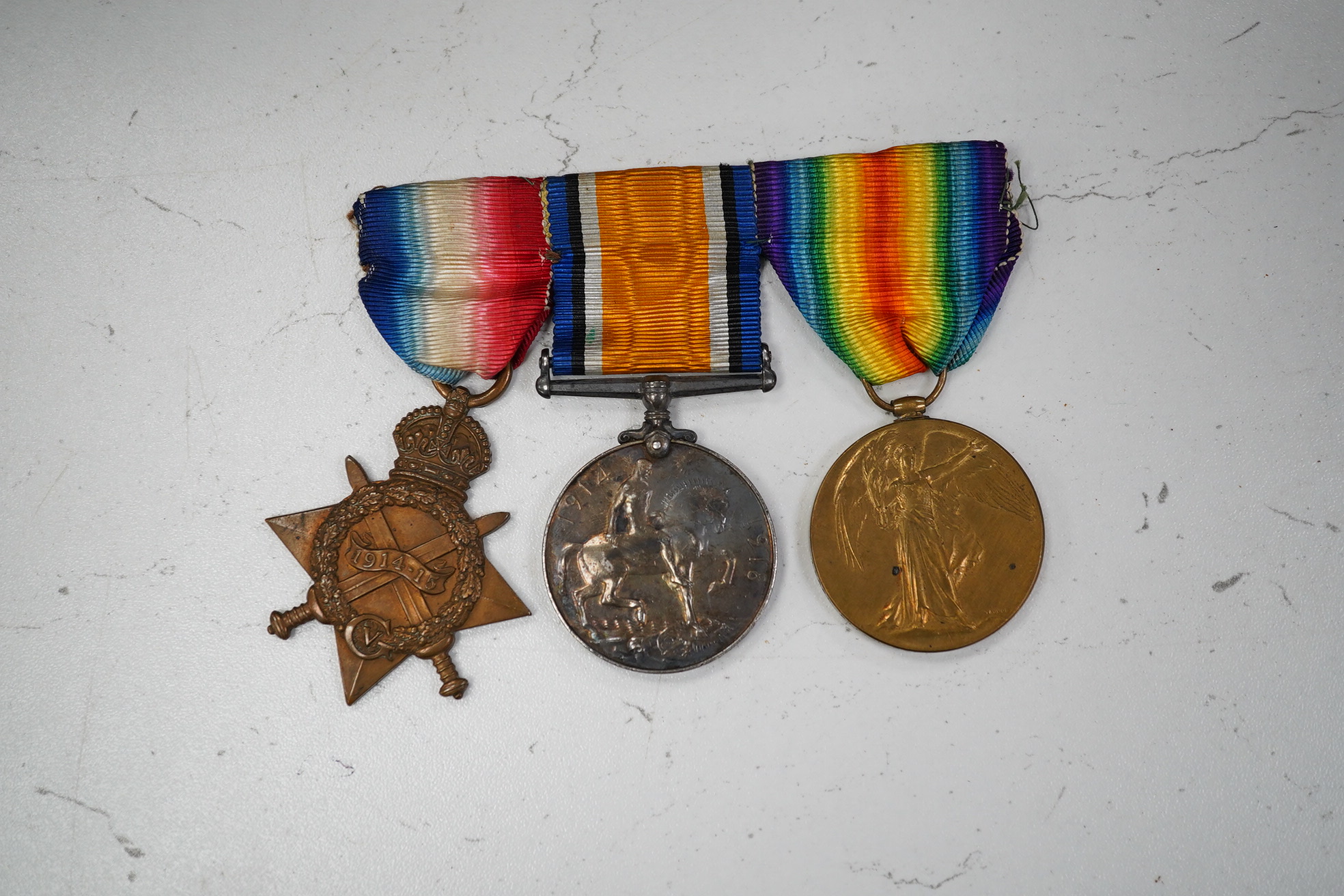 A First World War medal trio awarded to Pte. J. Ball Oxf. & Bucks. L.I., together with an oak mantle clock inset with a memorial plaque awarded to George John Ball, plus related paperwork. Condition - fair to good